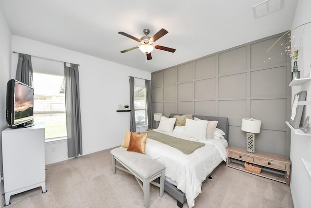 bedroom featuring light carpet and ceiling fan