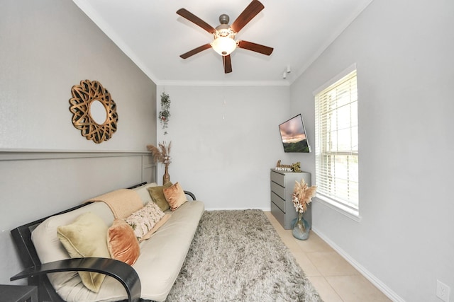 living area featuring light tile patterned flooring, ornamental molding, plenty of natural light, and ceiling fan