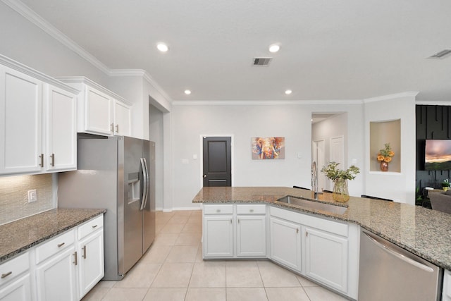 kitchen featuring stainless steel appliances, white cabinetry, sink, and stone counters