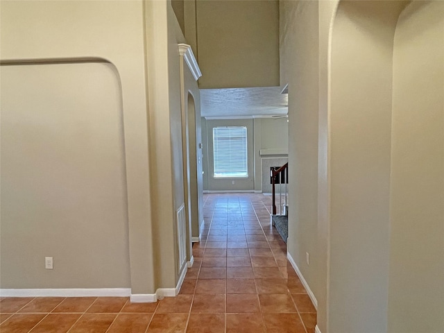 hall featuring light tile patterned floors