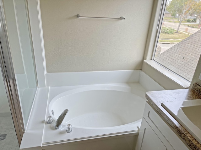 bathroom with vanity and a bathtub