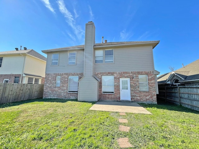 back of property with a patio and a lawn