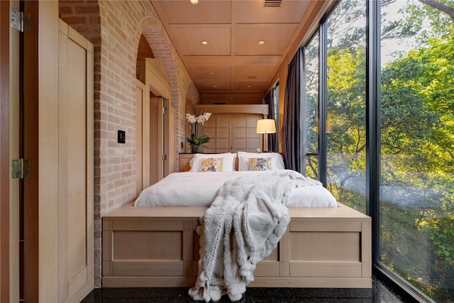 unfurnished bedroom featuring wood ceiling, brick wall, and visible vents