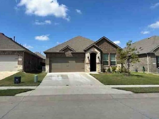 view of front of property with a garage and a front lawn