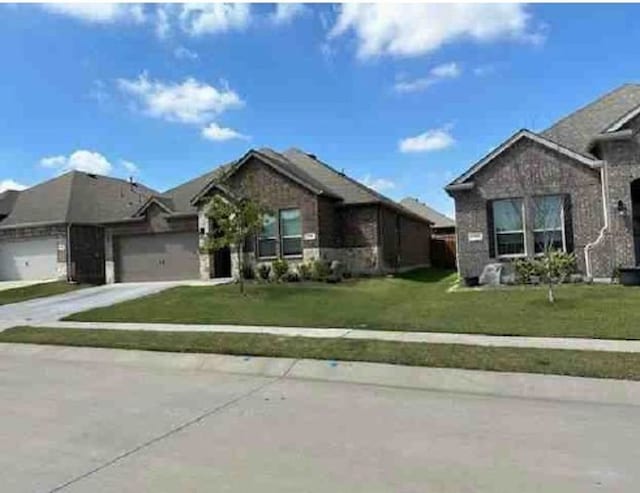 view of front of property with a garage and a front lawn