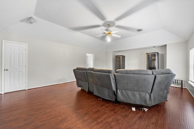 living room featuring lofted ceiling, a tray ceiling, dark hardwood / wood-style floors, and ceiling fan