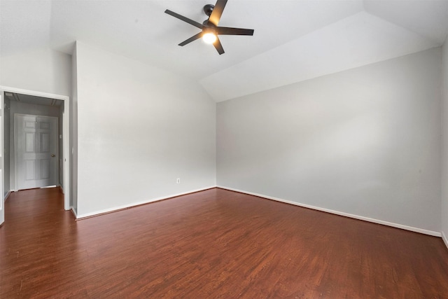 empty room featuring ceiling fan, dark hardwood / wood-style floors, and vaulted ceiling