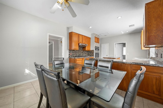 tiled dining room with ceiling fan