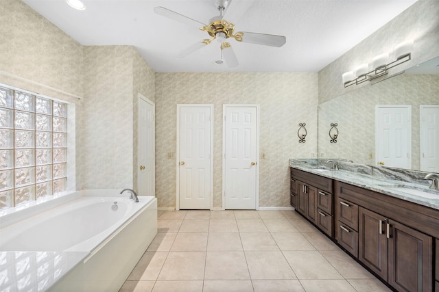 bathroom featuring vanity, a bath, tile patterned floors, and ceiling fan