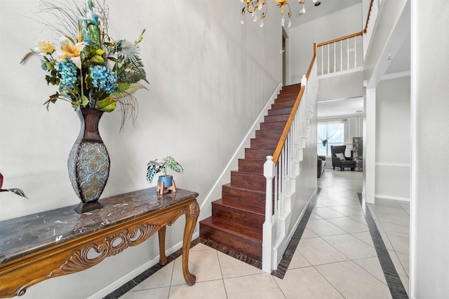 staircase featuring tile patterned flooring and ornamental molding