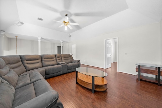 living room featuring ornate columns, vaulted ceiling, dark wood-type flooring, and ceiling fan