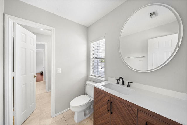 bathroom featuring tile patterned floors, toilet, and vanity