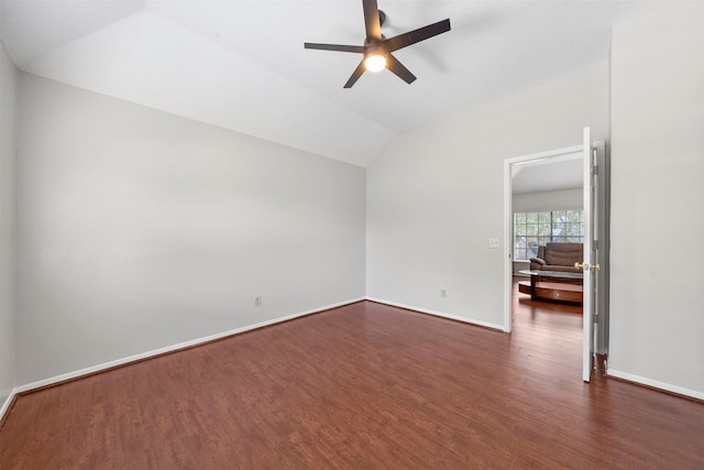 empty room featuring vaulted ceiling, dark hardwood / wood-style floors, and ceiling fan