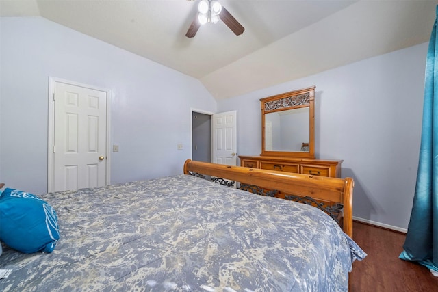 bedroom featuring vaulted ceiling, dark hardwood / wood-style floors, and ceiling fan