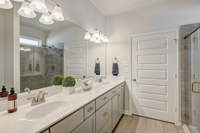 bathroom featuring vanity, hardwood / wood-style flooring, and a shower with shower door