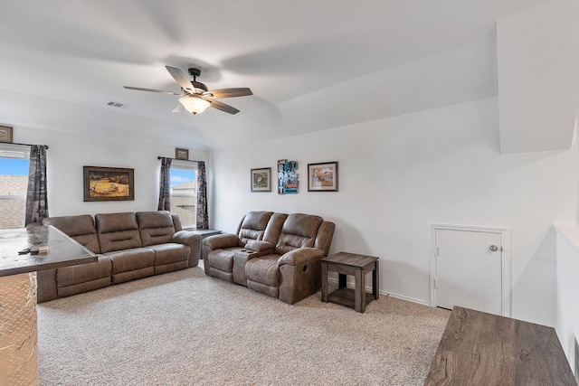 living room with a wealth of natural light, light colored carpet, and ceiling fan