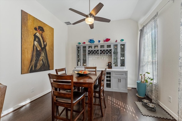 dining area with lofted ceiling, ceiling fan, bar, dark hardwood / wood-style flooring, and beverage cooler