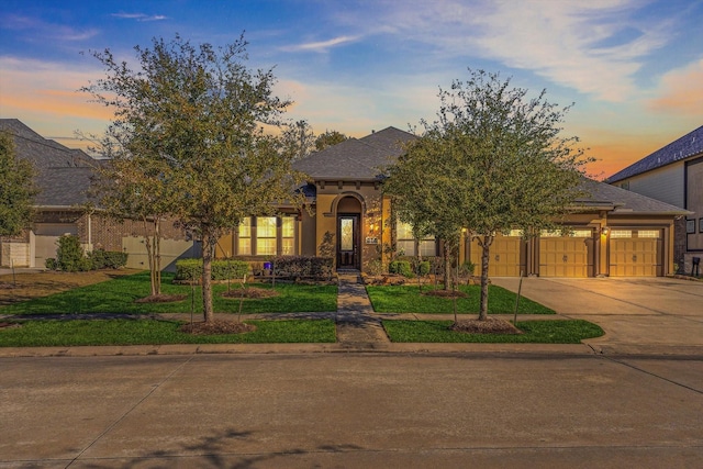 view of front facade with a garage and a yard