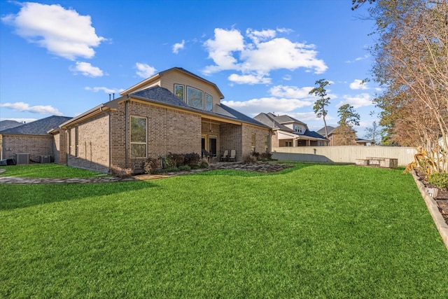 rear view of property with a lawn