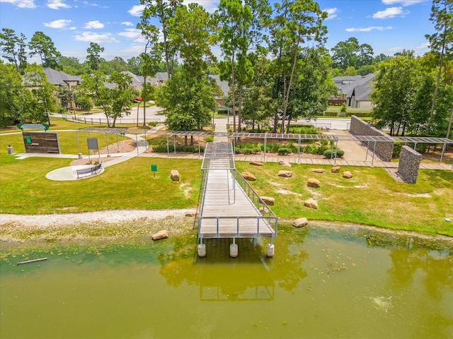 view of community featuring a water view and a lawn