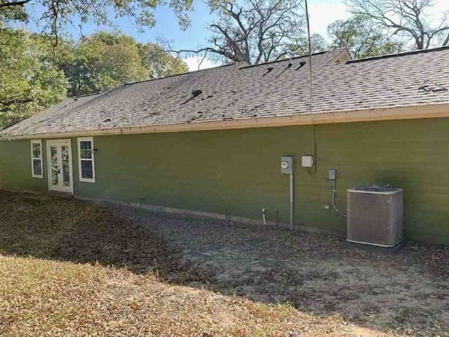 view of side of home featuring central AC unit