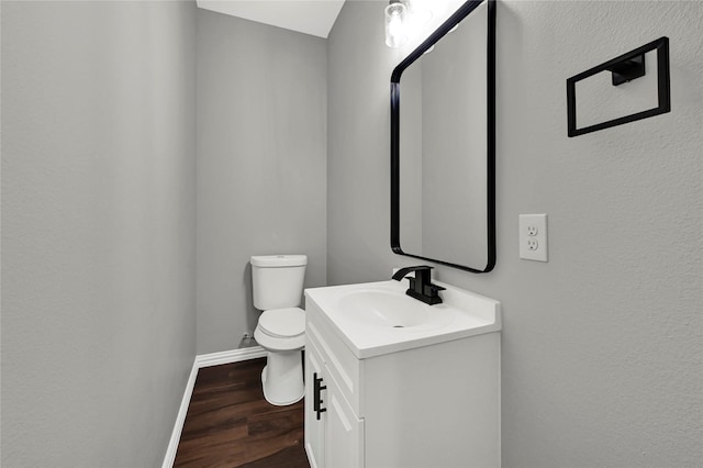 bathroom featuring hardwood / wood-style flooring, vanity, and toilet