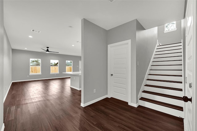 unfurnished living room with baseboards, a ceiling fan, stairway, dark wood-style flooring, and recessed lighting