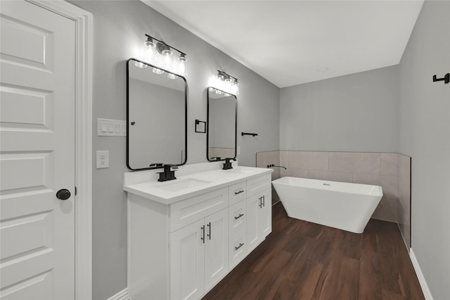 bathroom featuring vanity, hardwood / wood-style flooring, and a bathing tub