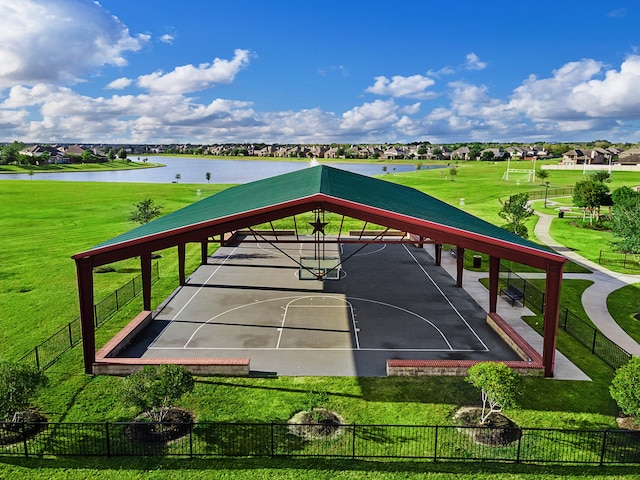 surrounding community featuring a water view, a yard, and basketball hoop