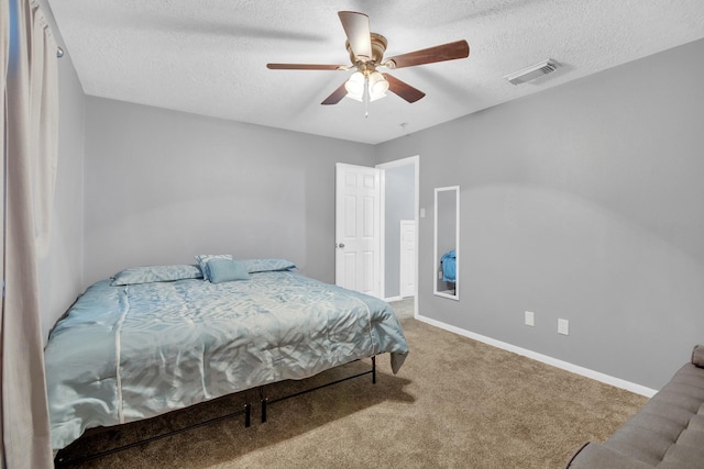 bedroom featuring ceiling fan, carpet flooring, and a textured ceiling