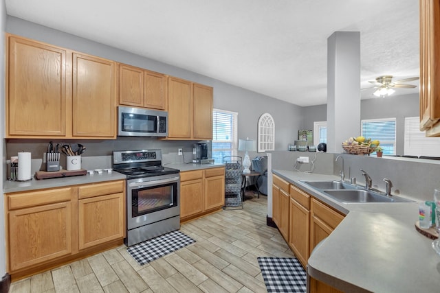 kitchen featuring stainless steel appliances, sink, and light brown cabinets