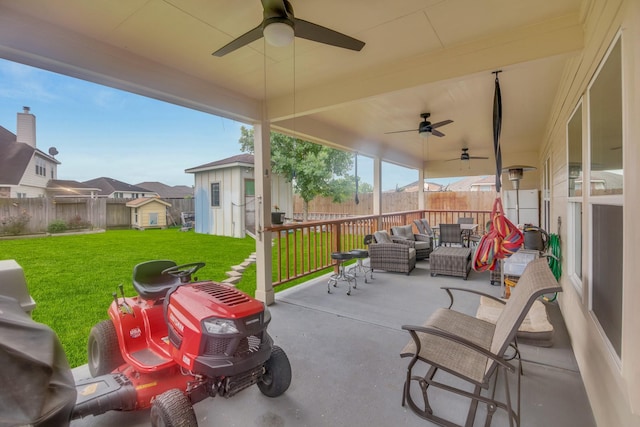 view of patio with an outdoor living space, an outdoor structure, a grill, and ceiling fan