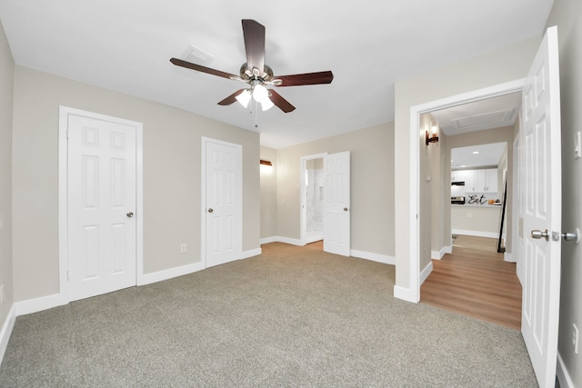 unfurnished bedroom featuring ceiling fan and carpet