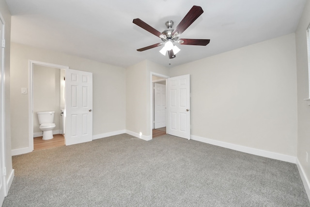 unfurnished bedroom with connected bathroom, ceiling fan, and carpet flooring