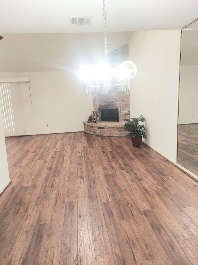 unfurnished living room featuring a fireplace and hardwood / wood-style floors