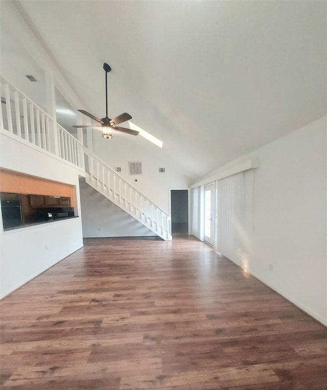 unfurnished living room with wood-type flooring, high vaulted ceiling, and ceiling fan