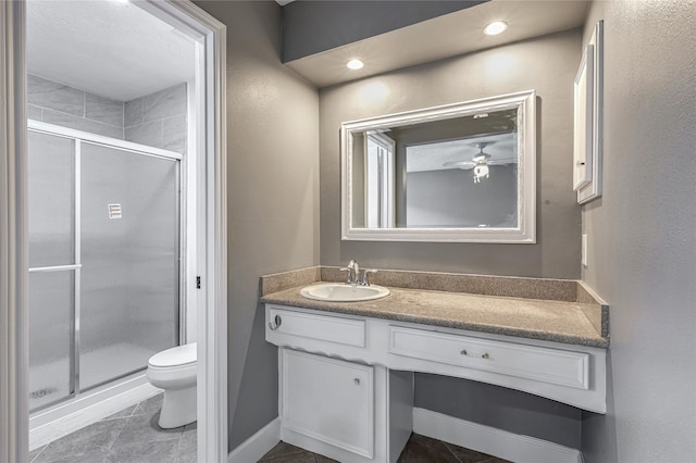 bathroom featuring a shower with door, vanity, tile patterned flooring, and toilet