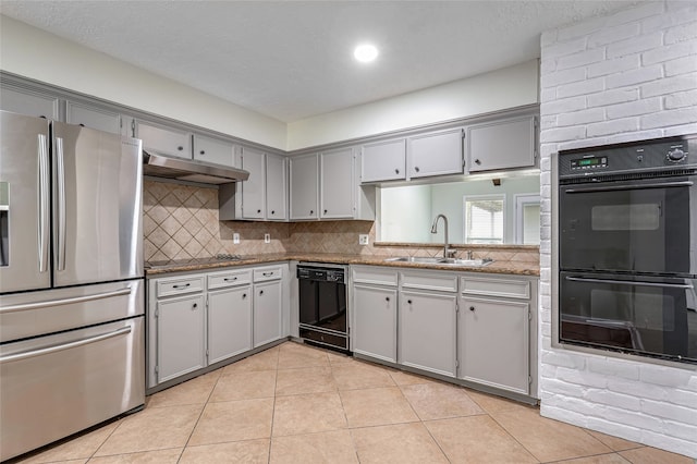 kitchen featuring gray cabinetry, light tile patterned floors, sink, and black appliances