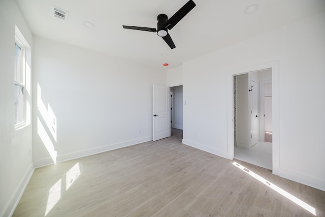 unfurnished bedroom with light wood finished floors, baseboards, visible vents, and ceiling fan