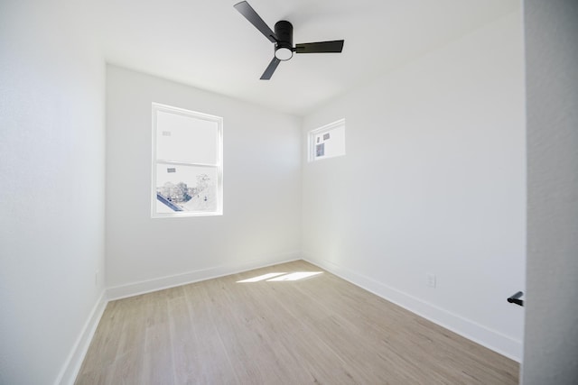 empty room featuring light wood-style floors, baseboards, and a ceiling fan