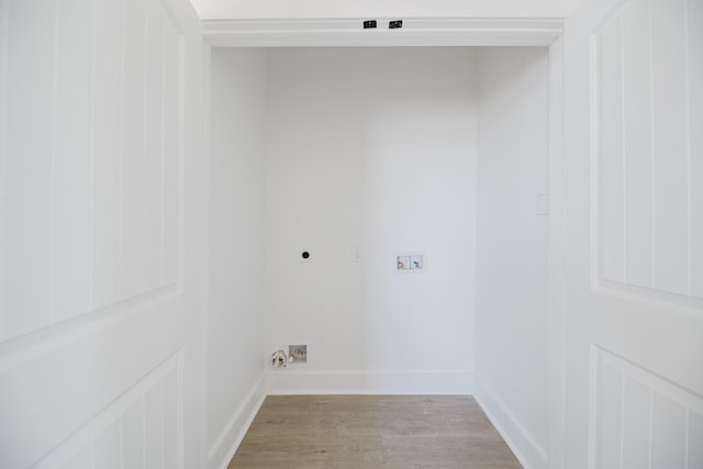 laundry room with baseboards, washer hookup, light wood-type flooring, and hookup for an electric dryer