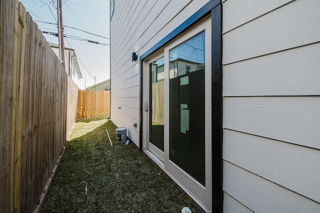 view of home's exterior featuring fence and a yard