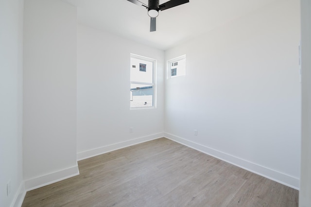 empty room with light wood-style floors, baseboards, and a ceiling fan