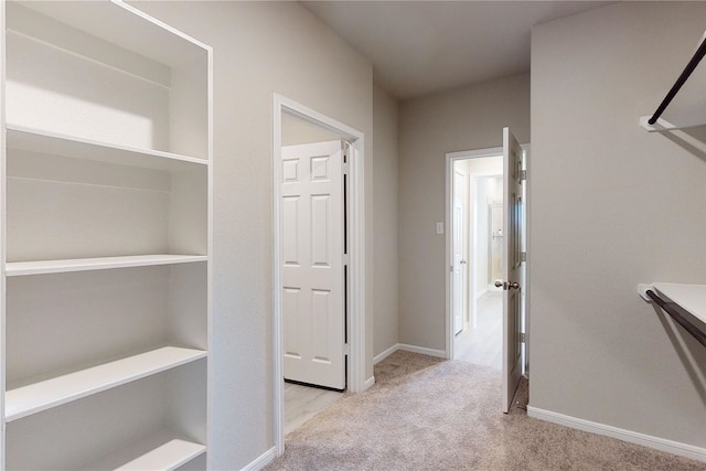 hallway with light colored carpet