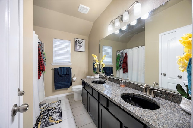 bathroom featuring lofted ceiling, toilet, tile patterned flooring, and vanity