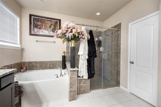 bathroom featuring a healthy amount of sunlight, vanity, shower with separate bathtub, and tile patterned flooring