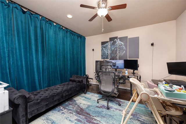 home office featuring hardwood / wood-style floors and ceiling fan