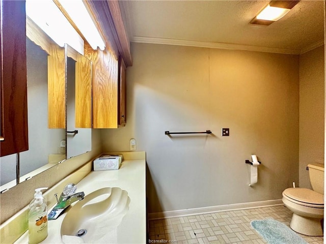 bathroom featuring crown molding, toilet, and sink