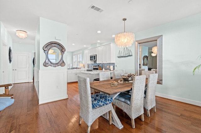 4241 Pointe W Dr Unit 301, Galveston, TX 77554 - dining room with a chandelier, hardwood / wood-style floors, baseboards, and recessed lighting