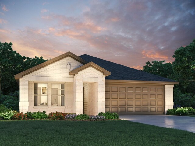 view of front facade with a yard and a garage